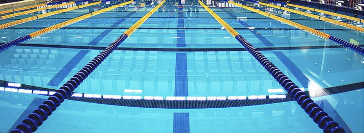 A swimming pool with floaters on the surface that stops water from spilling over the floor.